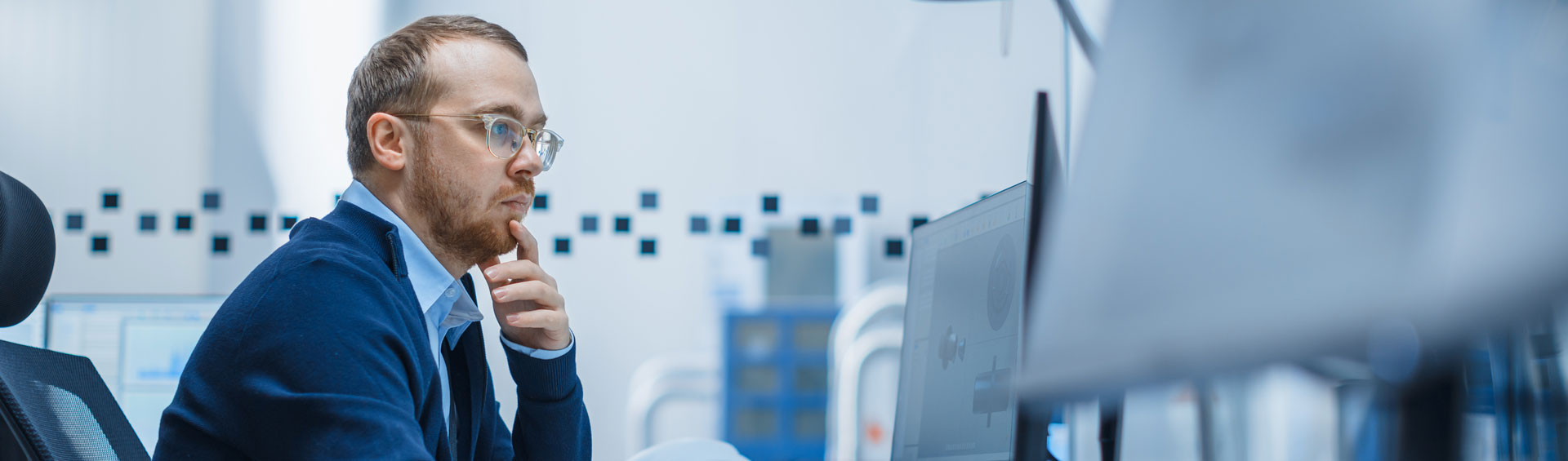 Man with glasses looking at computer