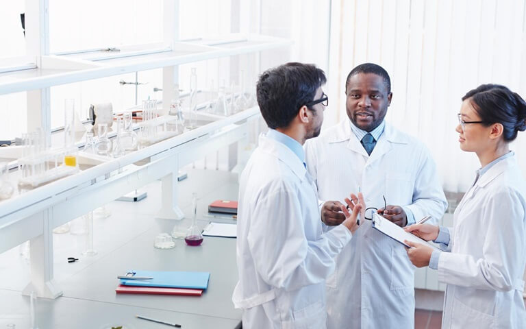 three lab technicians having a discussion