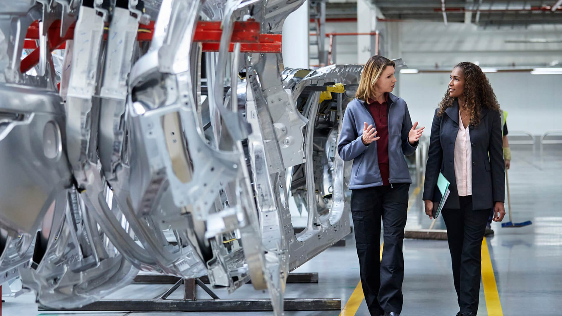 Two female automotive industry experts discussing the impacts of the new tariff laws on the automotive industry.
