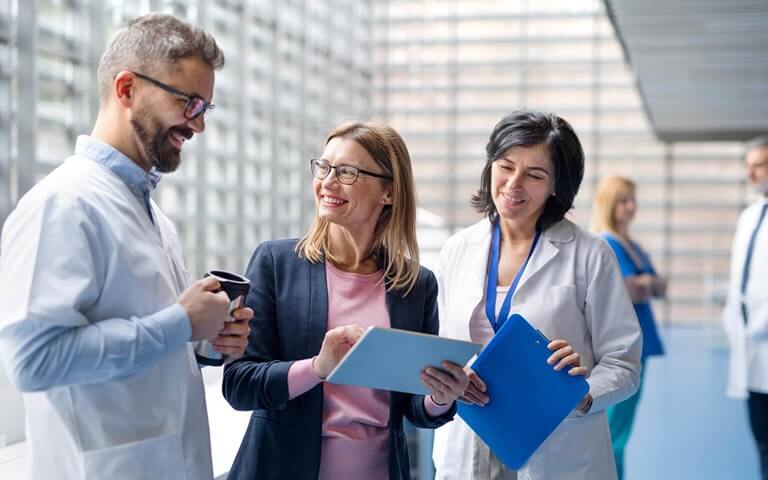 Colleagues reviewing info on tablet