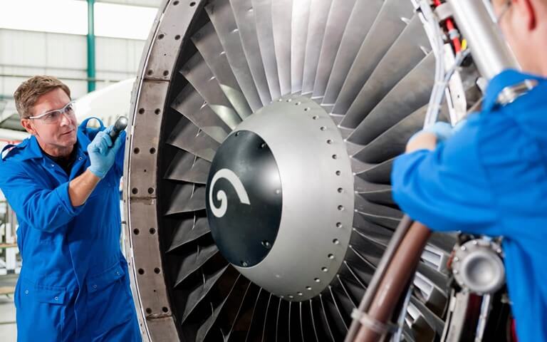 Two engineers working on jet propeller