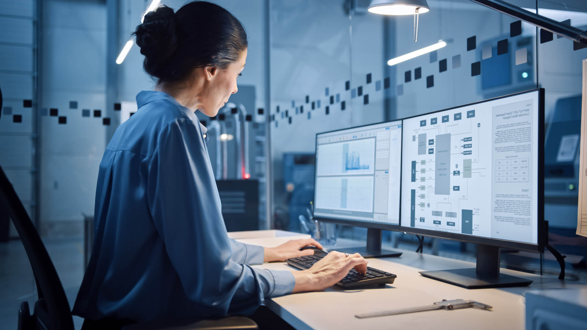 Female engineer developing an automated hoist design.