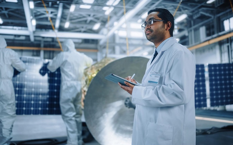 Space engineer working on satellite construction
