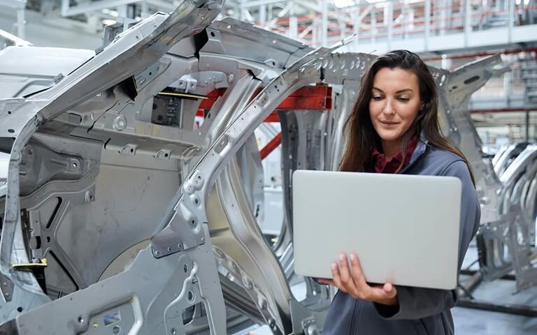 Female engineer with laptop in work area