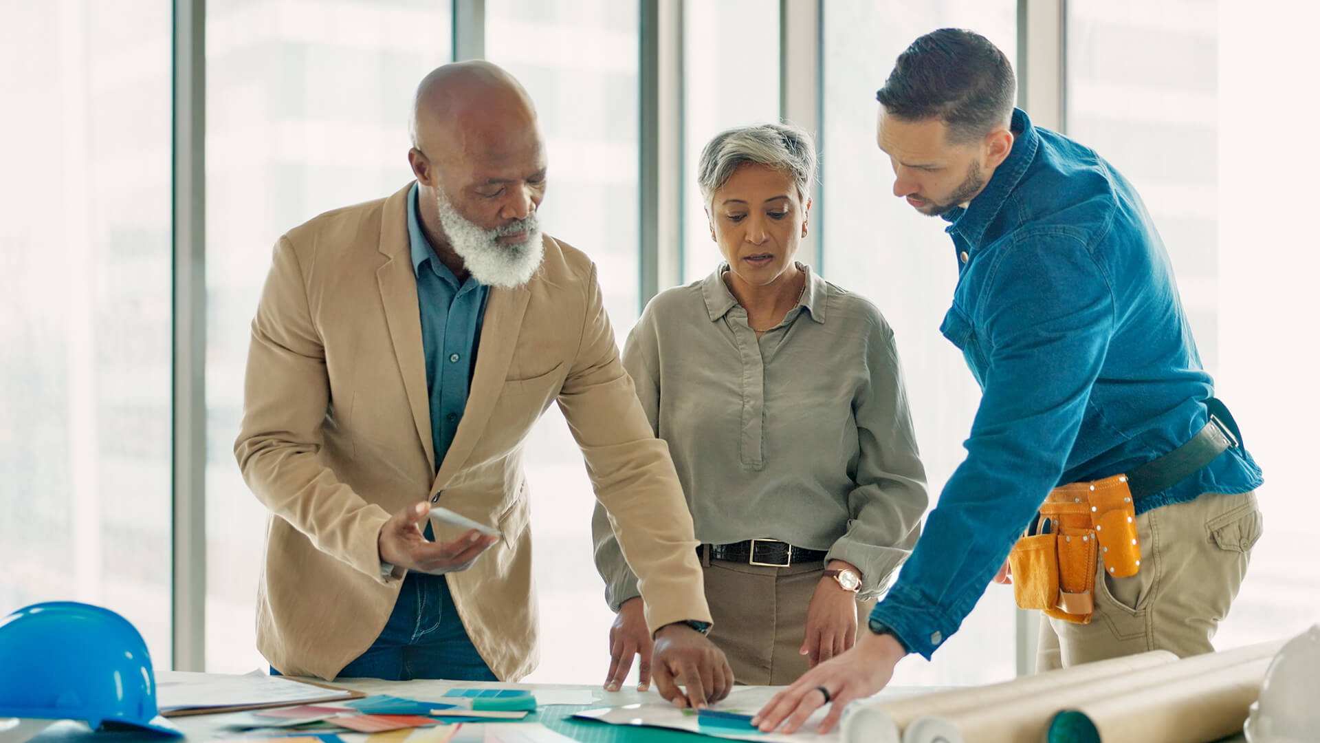 Three architectural designers working on a project for a small architecture and design firm to stay competitive and win new projects in the construction industry. 