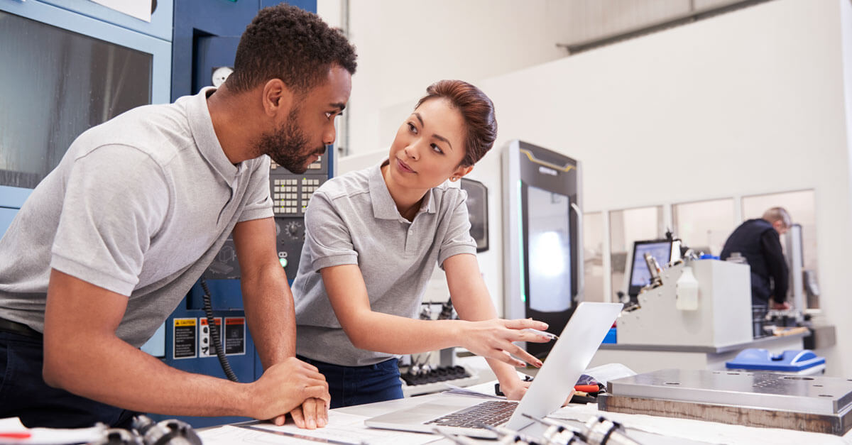 man and woman working in a lab on a laptop