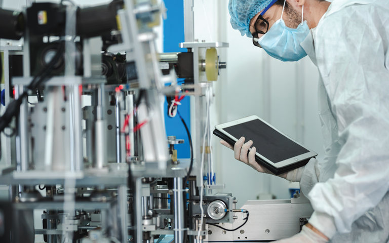 healthcare worker in laboratory using ipad