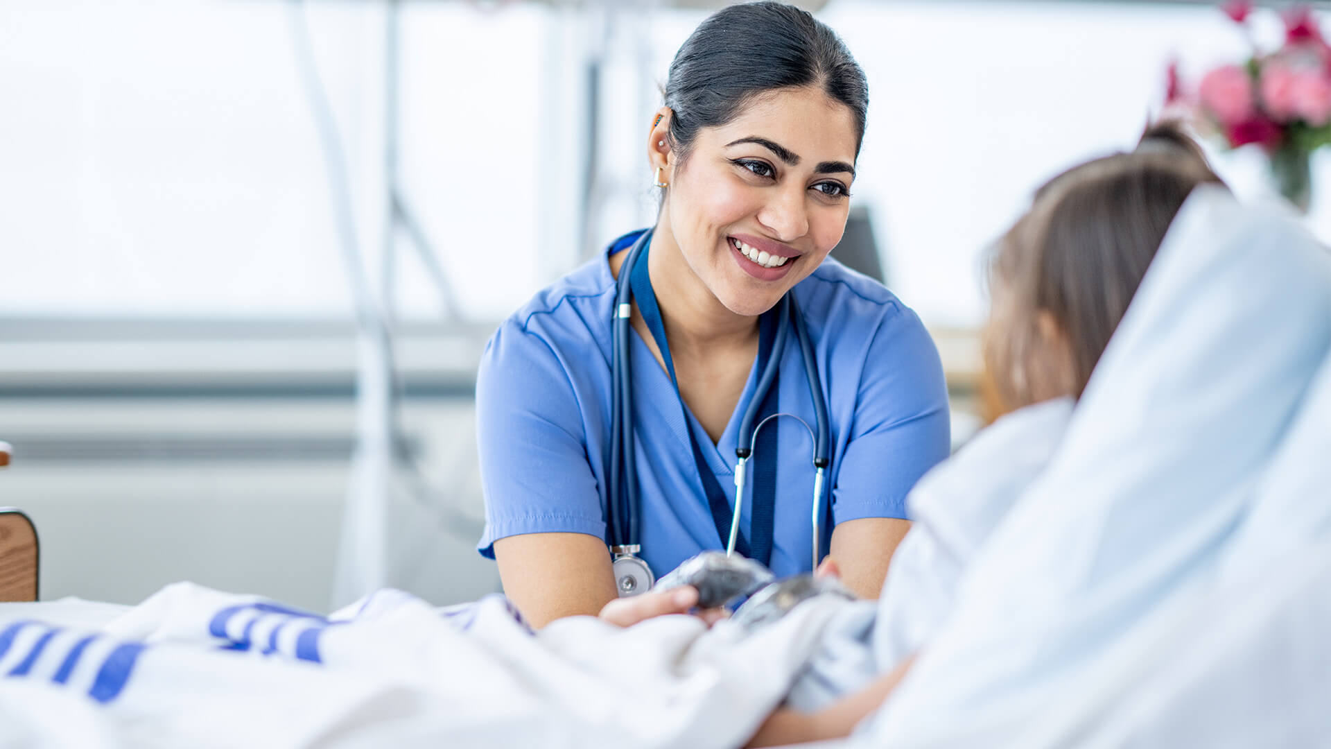 Female medical assistant providing quality patient care in a pediatric hospital.