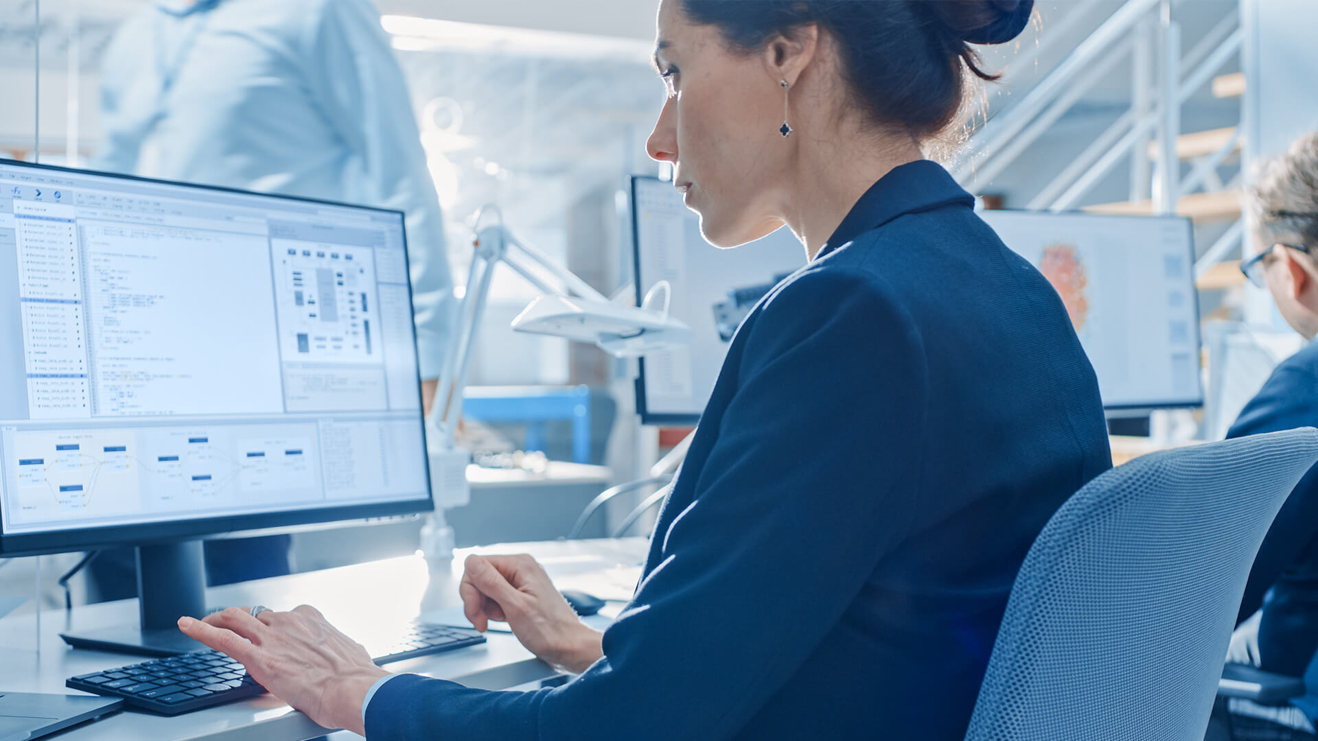 Female hiring manager analyzing the clients needs on desktop computer to ensure the hiring process is streamlined.