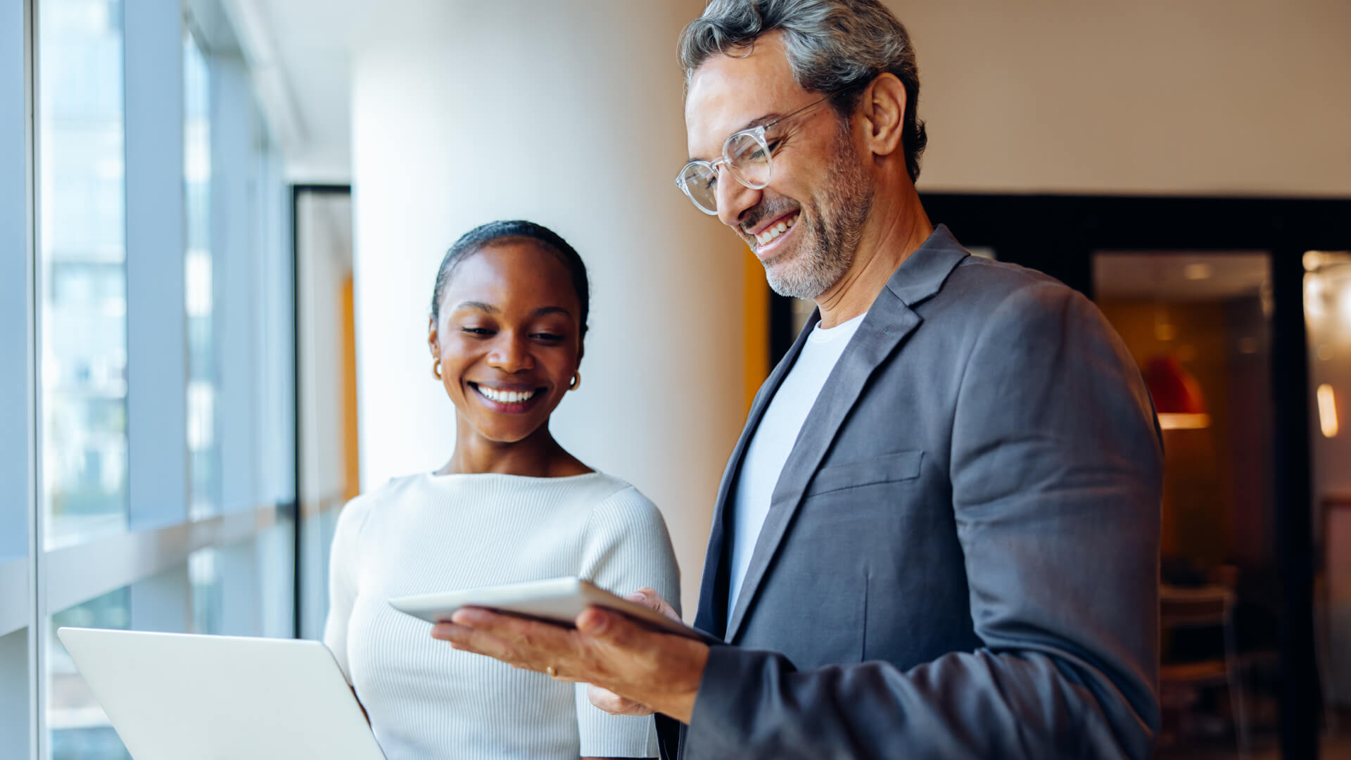 Male and female professionals reviewing the September 2026 jobs report looking at August 2026 labor market and economy trends.
